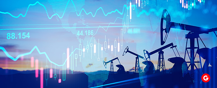 Oil pumps in the foreground with stock market graphs displayed in the background, illustrating the connection between energy and finance.