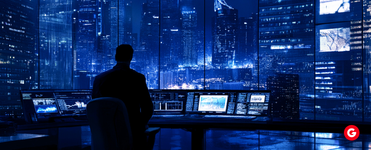 A man in a dark suit gazes intently at a computer screen, focused on his work or research.